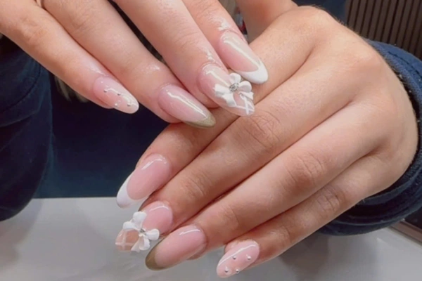 pink nails with white flower design